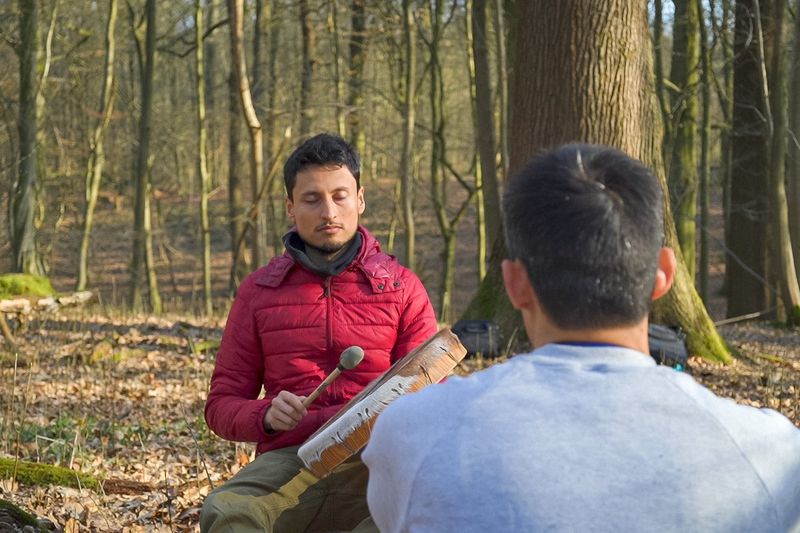 An outdoor one-to-one coaching session in a wooded setting